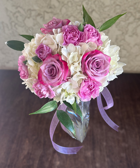Perfect Posy bouquet with hydrangea, matching roses, mini-carnations, and a satin bow
