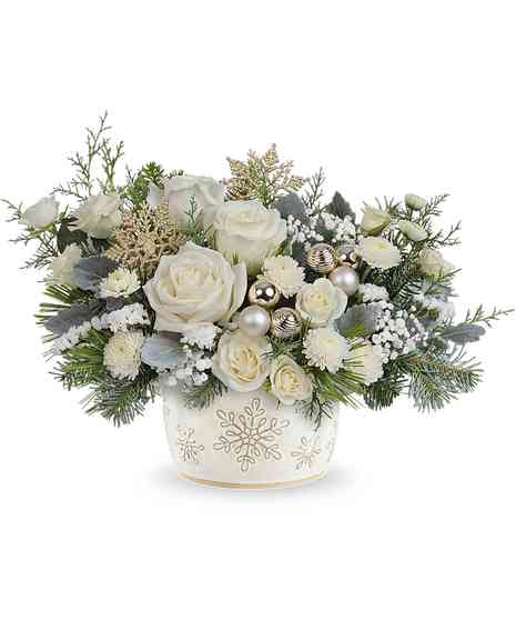 Starry Snowflakes Bouquet with white roses, spray roses, button mums, baby's breath, and winter greens in a snowflake dish.