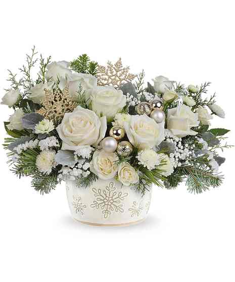 Starry Snowflakes Bouquet with white roses, spray roses, button mums, baby's breath, and winter greens in a snowflake dish.