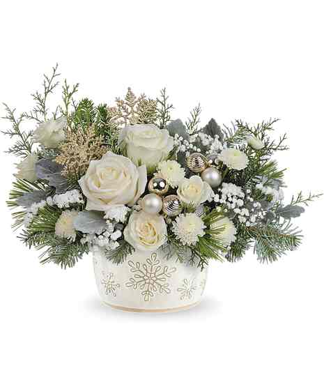 Starry Snowflakes Bouquet with white roses, spray roses, button mums, baby's breath, and winter greens in a snowflake dish.