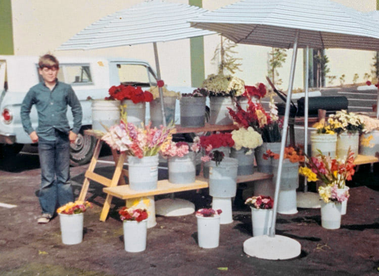 A young helper lends a hand at the flower booth in the late 70s